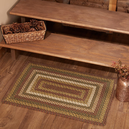 Small braided jute accent rug with green, red and cream stripes