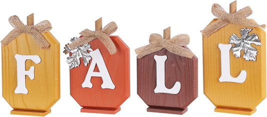 Four rustic wooden blocks spelling FALL with a jute bow